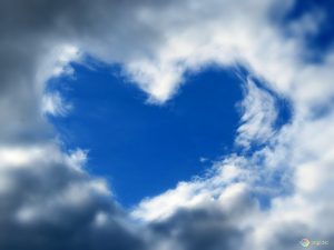 Blue sky heart created by surrounding clouds